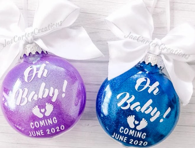 Two ornaments, side by side, that read "Oh Baby"