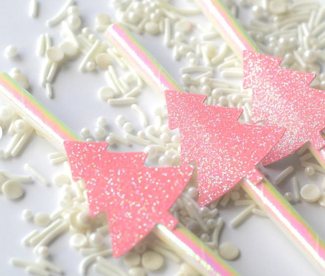 Close up of drinking straws with pink sparkly Christmas trees