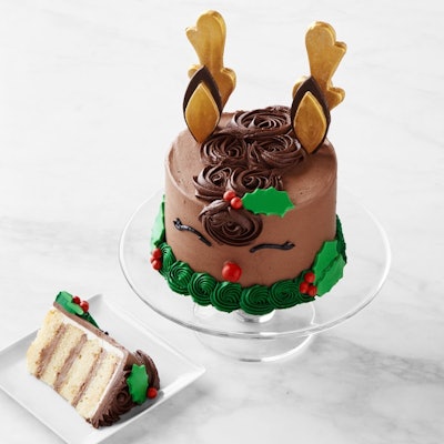 Cake decorated to look like a reindeer on a cake stand