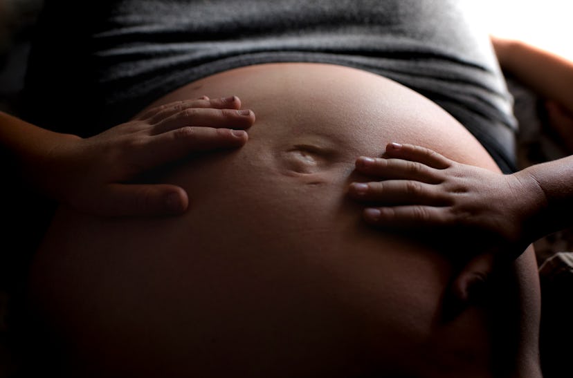 Children place their hands over a pregnant person's stomach. A suite of new AI-powered startups are ...