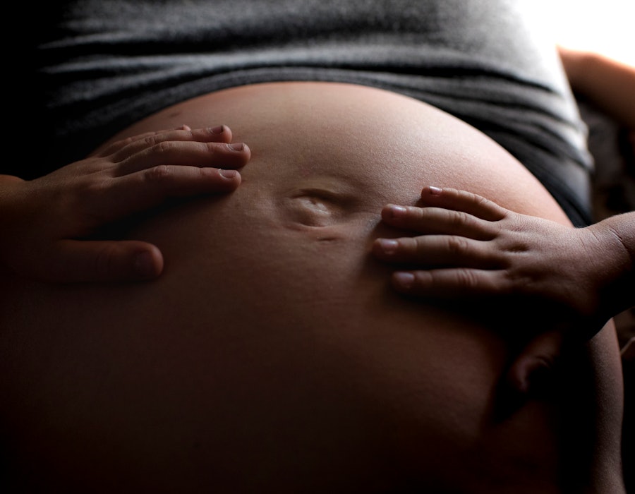 Children place their hands over a pregnant person's stomach. A suite of new AI-powered startups are ...