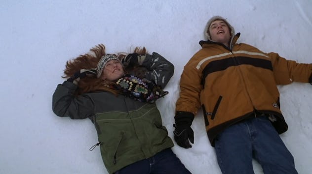 Two teens lie happily in the snow in Snow Day