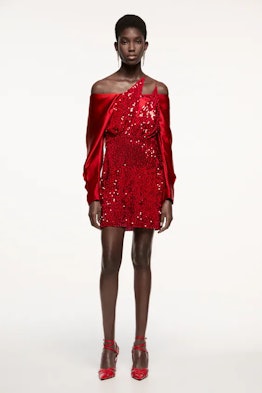 Woman modeling Zara's red, sequined dress.