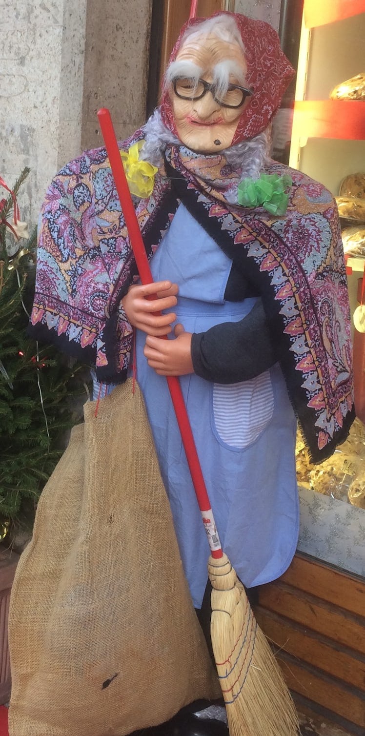 La Befana the italian christmas witch dall holding a broom