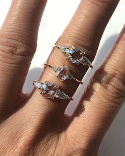 Three engagement rings on a hand, by Catbird.