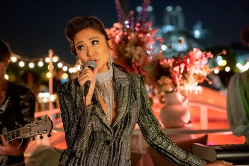Ashley Park's Mindy sings at an event in 'Emily in Paris' Season 2.
