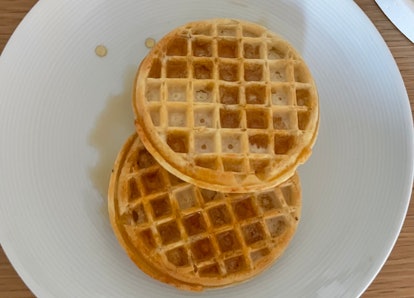 Two waffles on a plate.