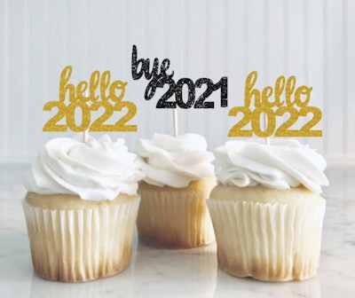 Three cupcakes with "hello 2022" and "bye 2021" toppers