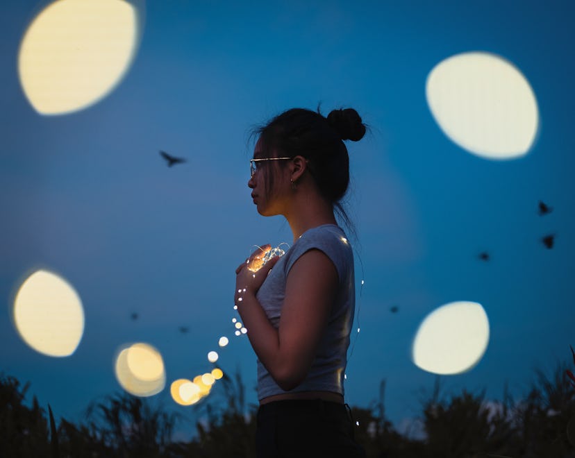 girl standing outdoors in the dark 