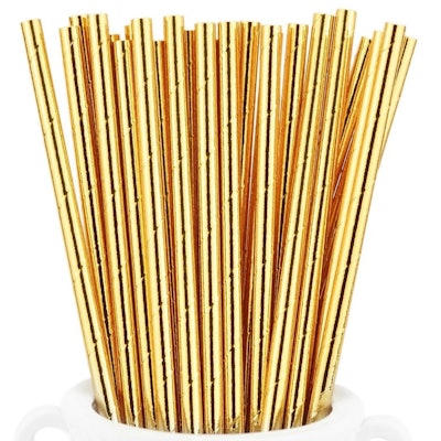 White cup full of gold paper straws