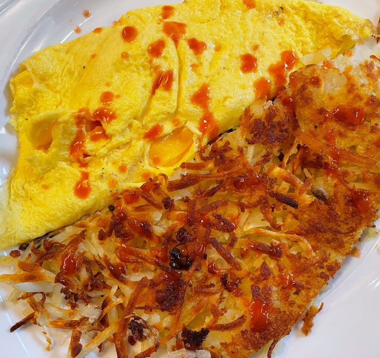 Omelet and hash browns on a plate.