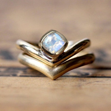 A bridal nesting ring set by Stephanie Maslow featuring a rainbow moonstone and modern v shaped wedd...