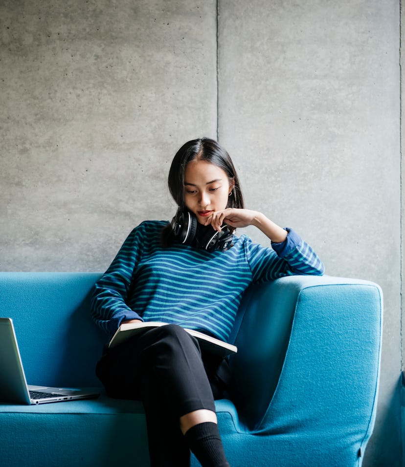 woman reading a book at the library