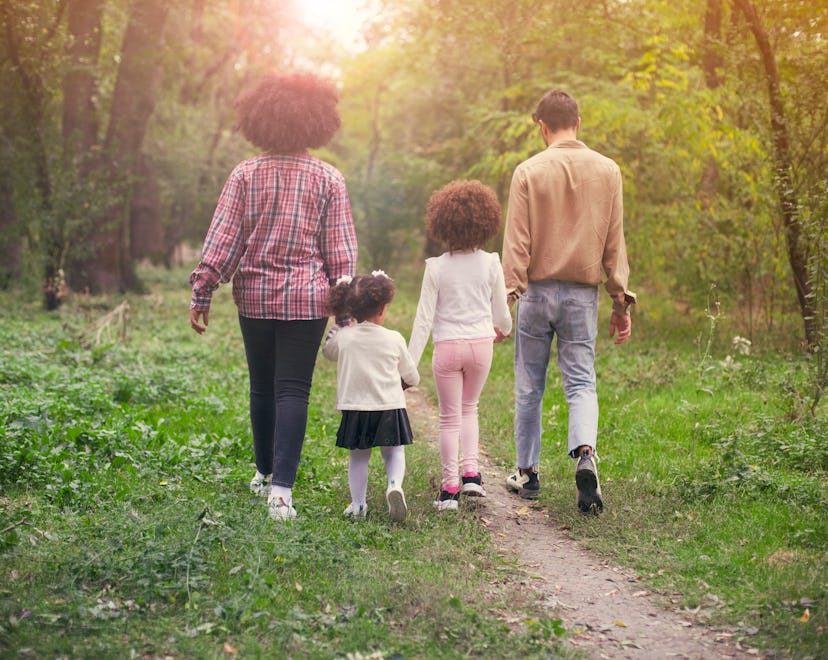 family walking along a path in the woods