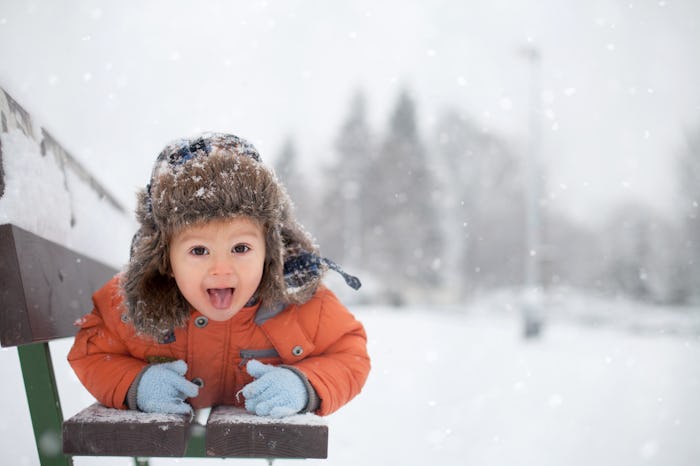 capricorn baby boy playing in the snow