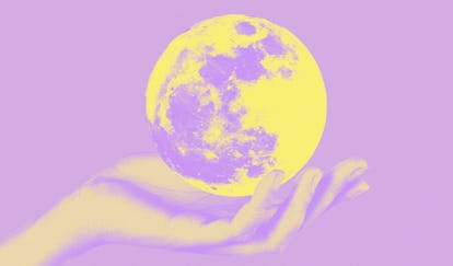 Young woman holding the moon in her hand to show the luckiest zodiac signs of 2022.