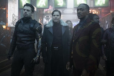 Falcon, Winter Solider, and Zemo standing in the crowd during a night