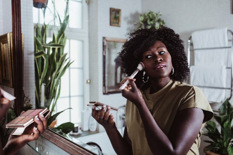 A woman applying makeup on dry skin, according to Beyonce's makeup artist.