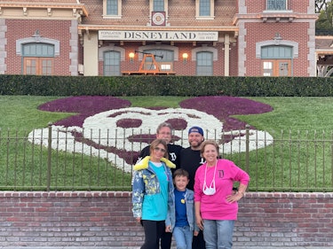 Justin with his mom, his stepson, his wife, Sasha, and his dad, Daniel at Disneyland