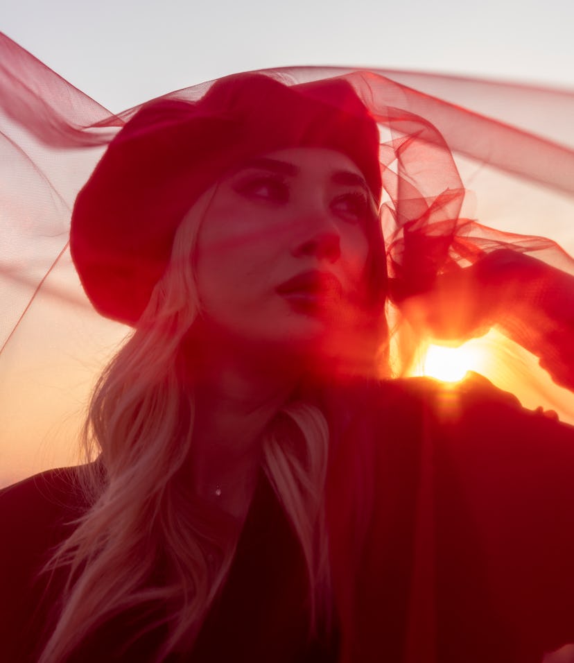 Young woman with a red shawl during Jupiter in Pisces 2021, which starts on Dec. 28.