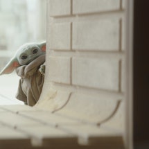 Baby Yoda peering around a corner in 'The Mandalorian'