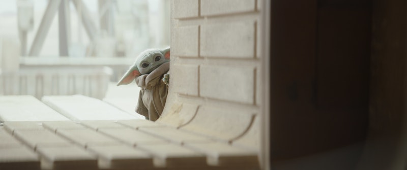 Baby Yoda peering around a corner in 'The Mandalorian'