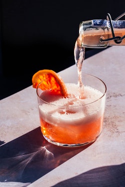 fizzy drink with orange slice garnish for a refreshing new year's eve cocktail