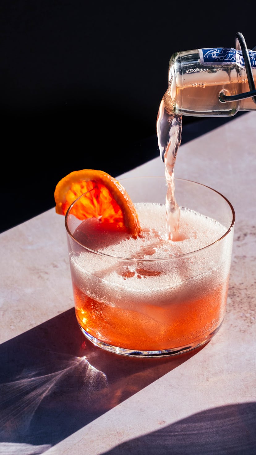 fizzy drink with orange slice garnish for a refreshing new year's eve cocktail