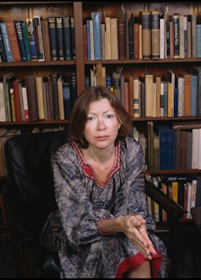 Joan Didion in front of books. 
