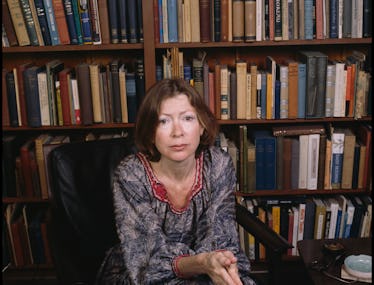 Joan Didion in front of books. 