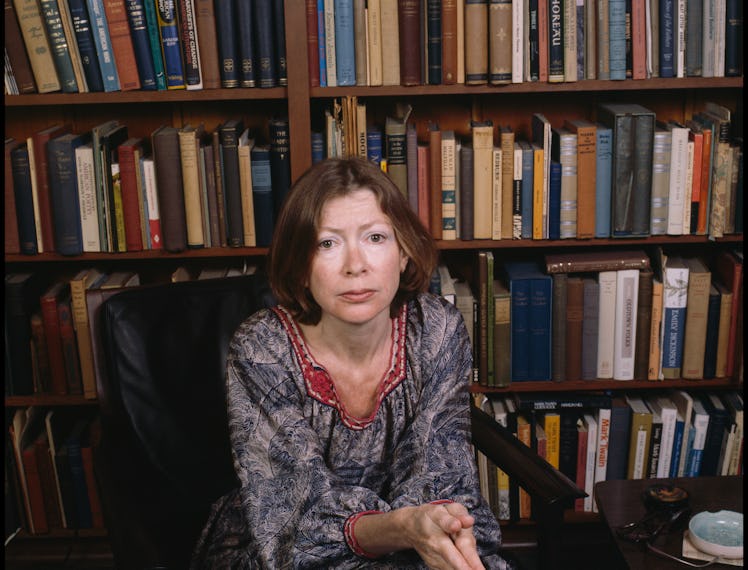 Joan Didion in front of books.