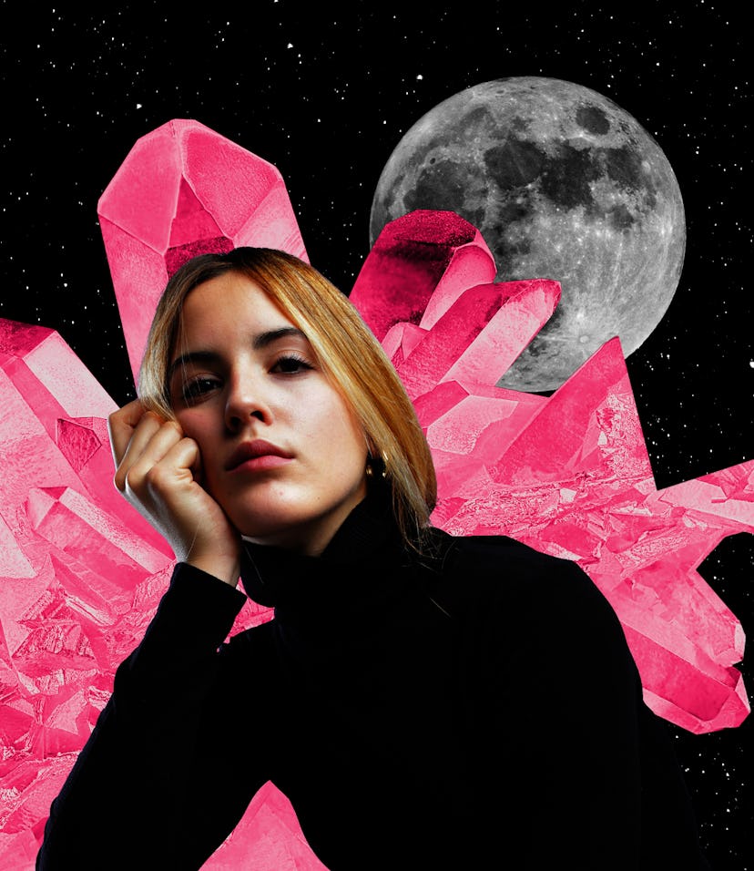 Young woman with crystals and a moon behind her to show that your 2022 yearly horoscope is swirling ...