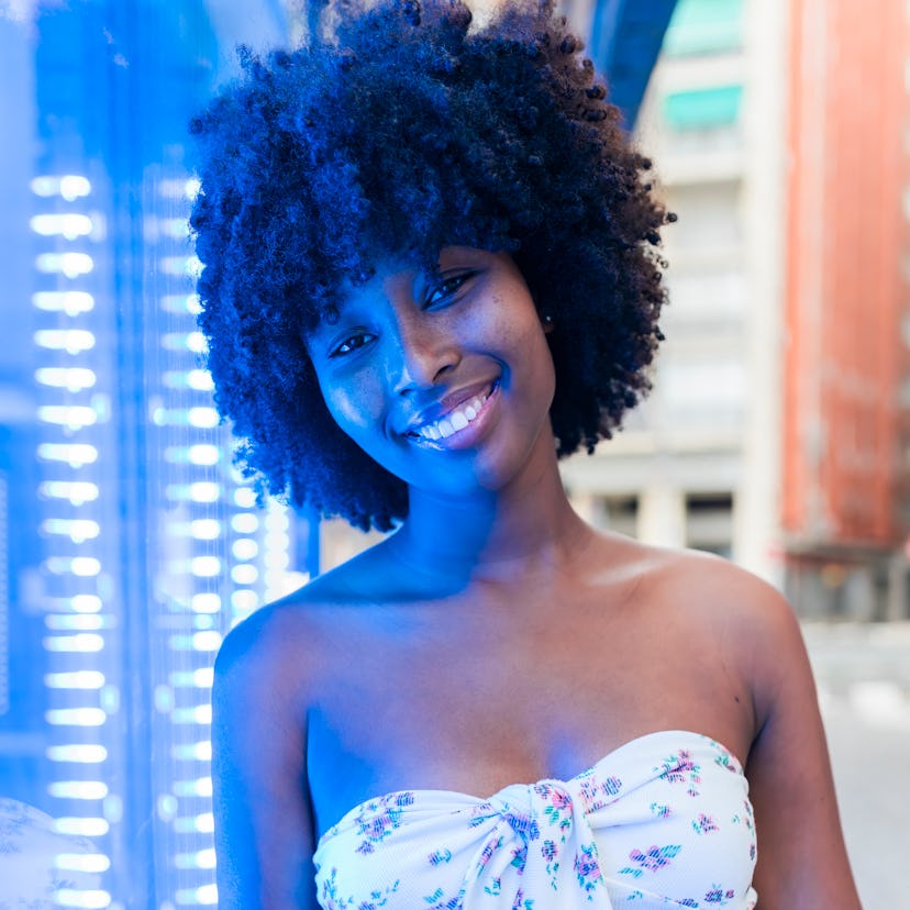 Young woman smiling on January 29, 2022, the best day of the month for every zodiac sign.