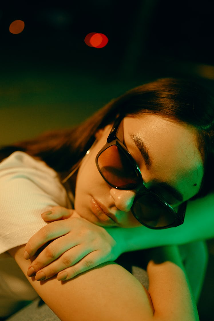 Young woman sad and holding back tears as one of the zodiac signs most likely to cry on Christmas 20...