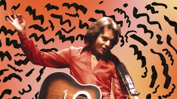 A young Neil Diamond in an orange shirt holding a guitar with an abstract orange and black backgroun...