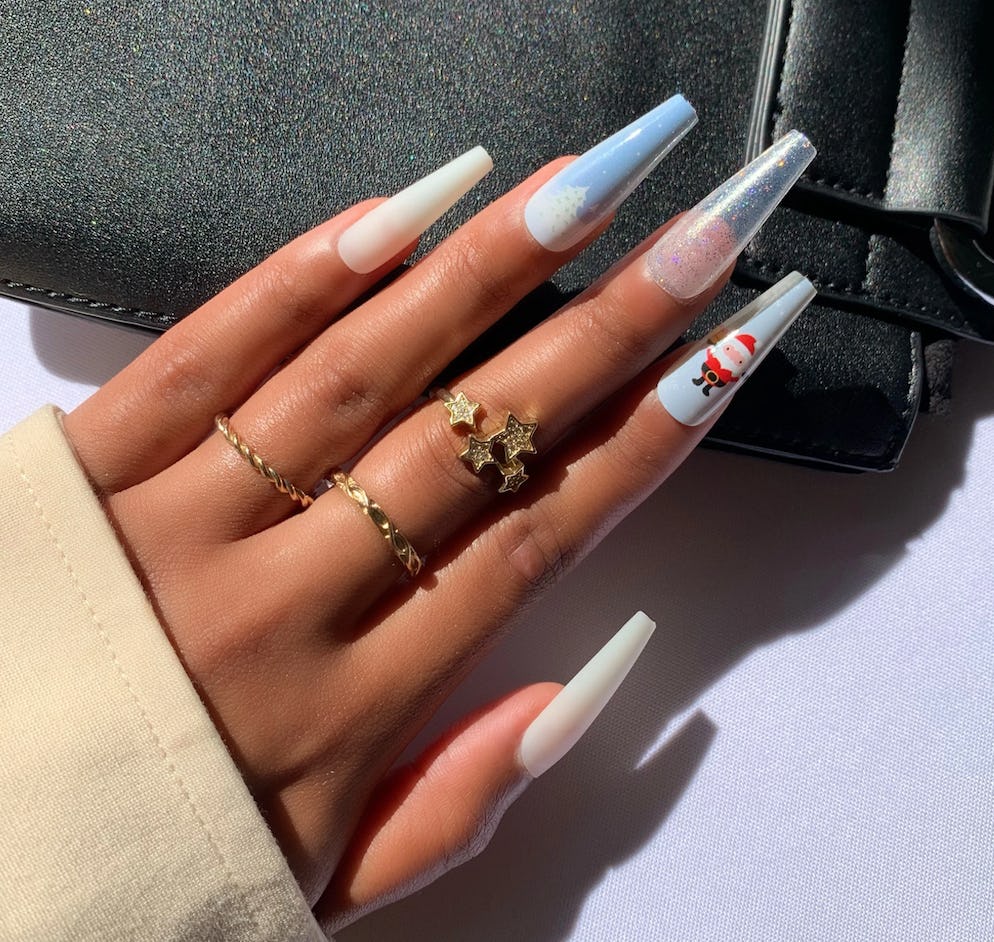 Long press-on nails and sets with a winter deseign, baby blue with some glitter and Santa