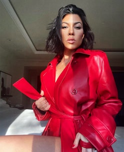 Kourtney Kardashian wearing a red jacket. 