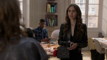 Lily Collins wearing a jacket and dress in Season 1, episode 6 of 'Emily in Paris'.