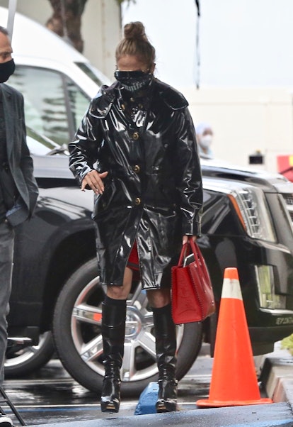 Jennifer Lopez in black Coach vinyl coat, 2021.