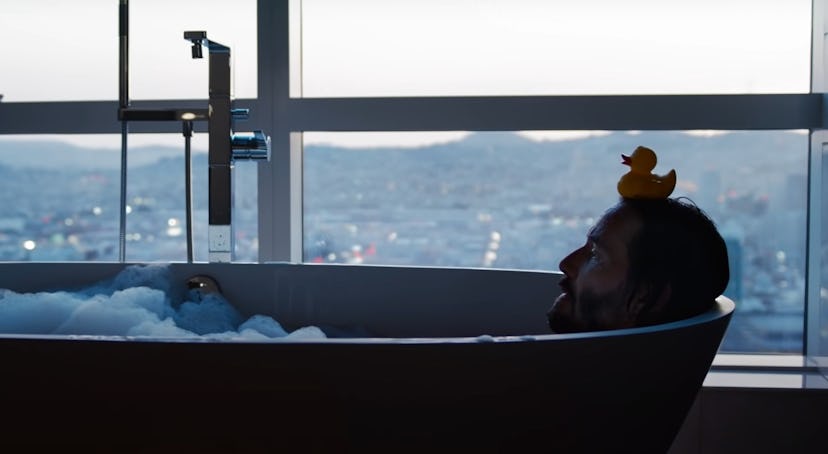 Keanu Reeves lying in bath in "The Matrix Resurrections"