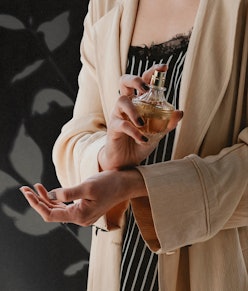 sexy perfume, woman applying fragrance to her wrists
