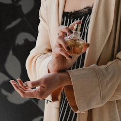 sexy perfume, woman applying fragrance to her wrists