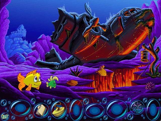 Screenshot of Freddi Fish 3 game showing two fish swimming with sunken, wrecked plane in background ...