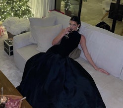 Kendall Jenner sitting in a black gown