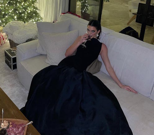 Kendall Jenner sitting in a black gown
