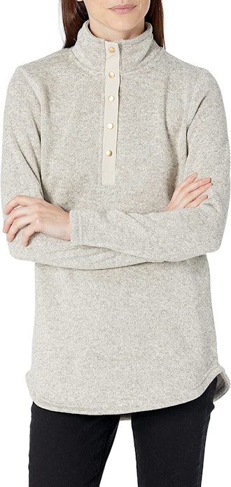 This cozy tunic sweater features a high collar and three-quarter button front. 