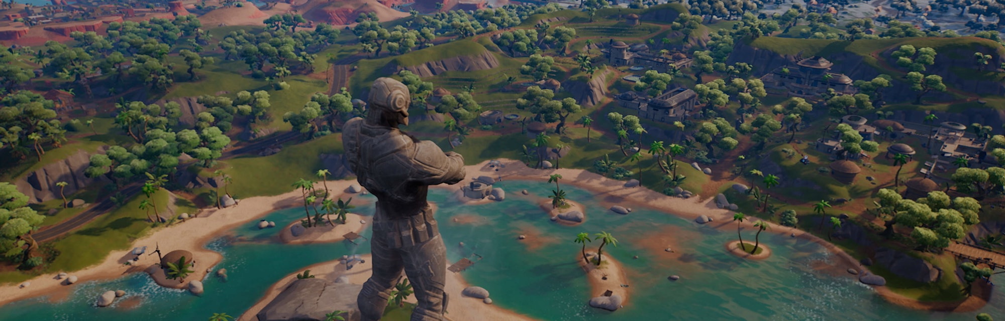 Screenshot of Fortnite Chapter 3 map, showing forests, desert and a tall stone statue of a futuristi...