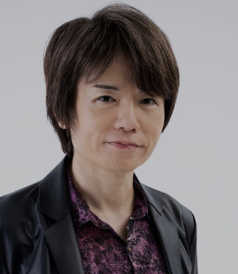 Image of Masahiro Sakurai with short brown hair wearing black leather blazer and maroon button-up sh...
