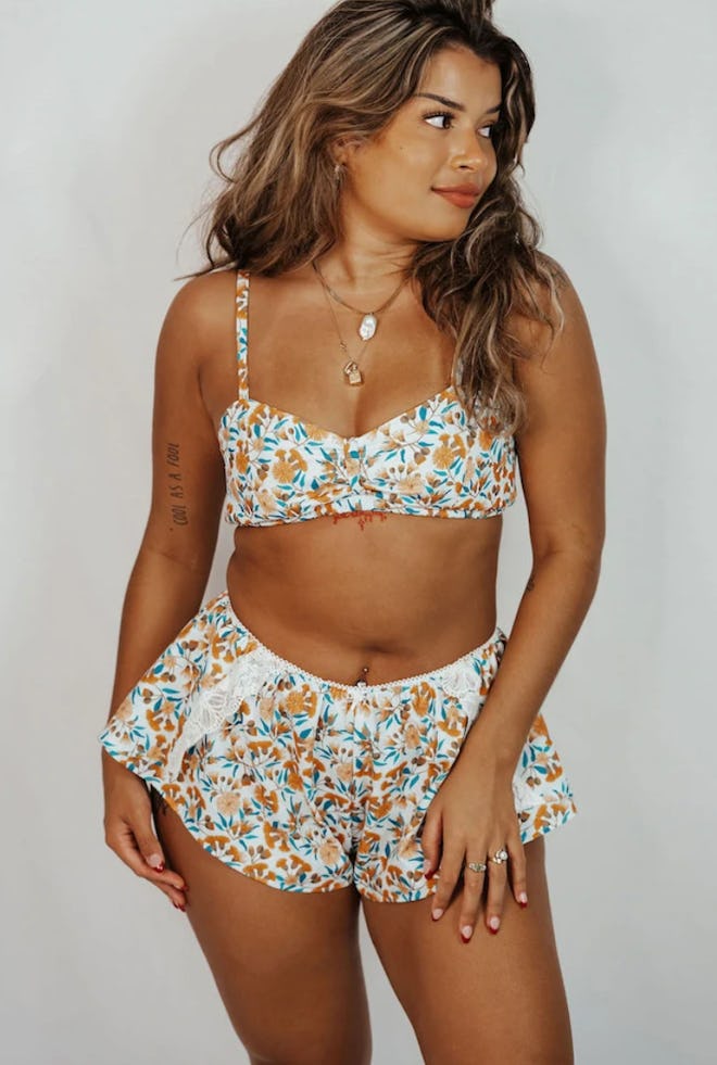 Image of a woman wearing a floral-print bralette and knicker shorts set.