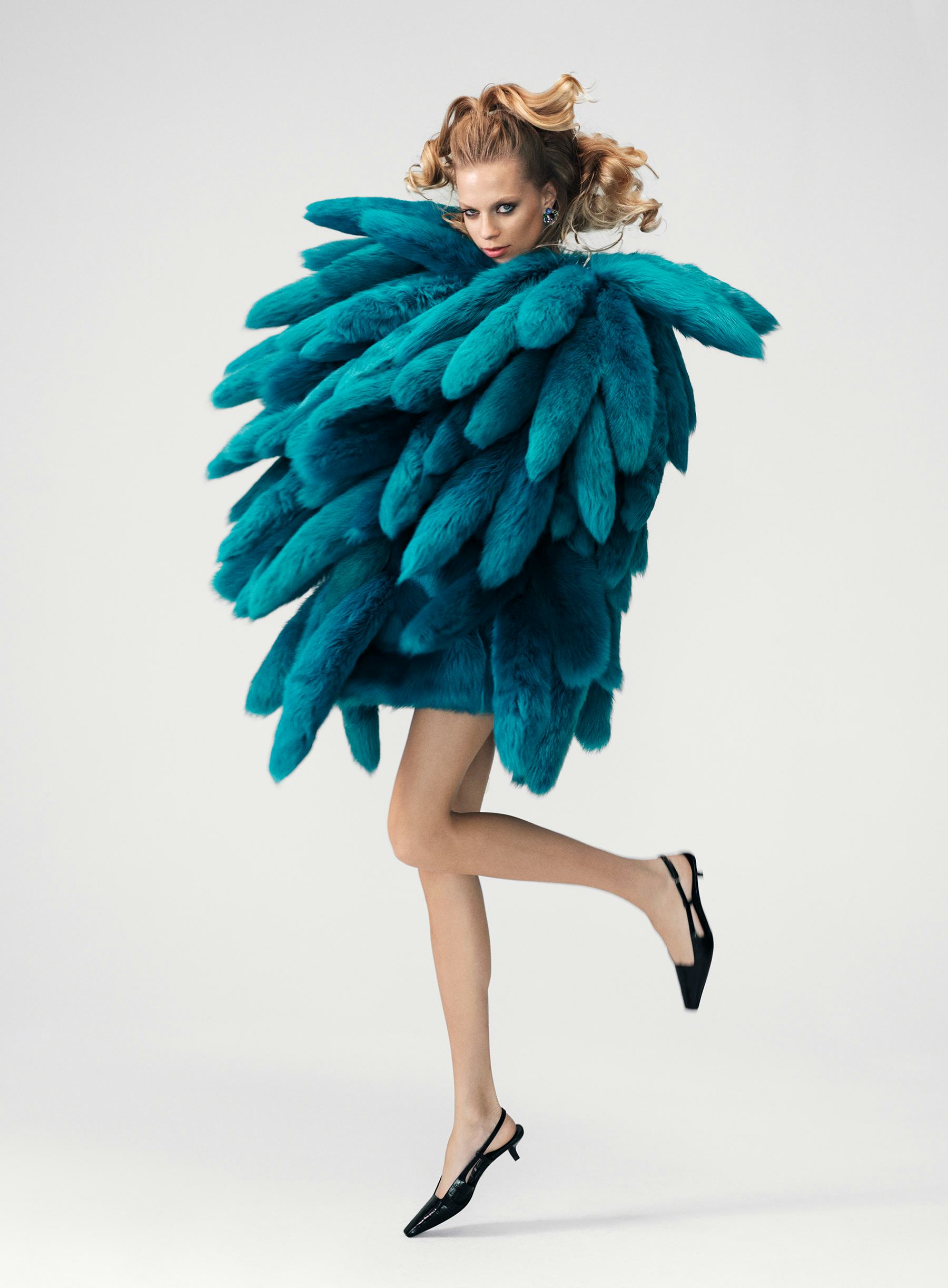 Lexi Boling wears a Bottega Veneta coat; Cartier earrings; Gucci shoes. 